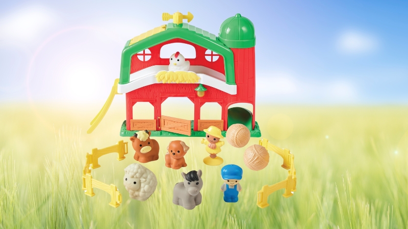 Kidoozie My First Farm Set with colorful animals, farmers, and a red barn displayed in a grassy field